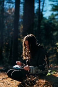 how to be inspired to write - girl writing in forest